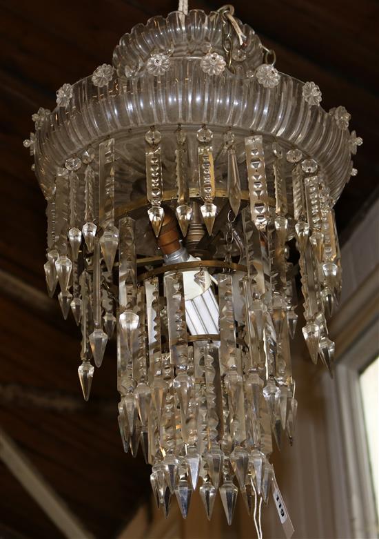 A cut glass four tier ceiling chandelier, hung faceted spear drops